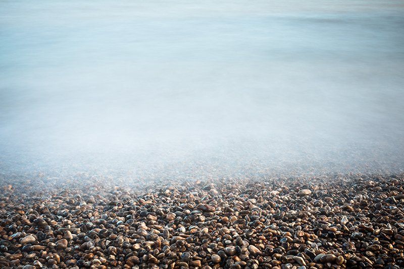 long exposure of tide over pebble beach